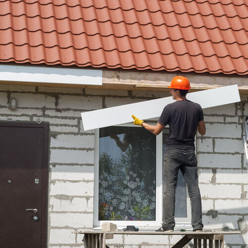A Roofer Installs Fascia Board.