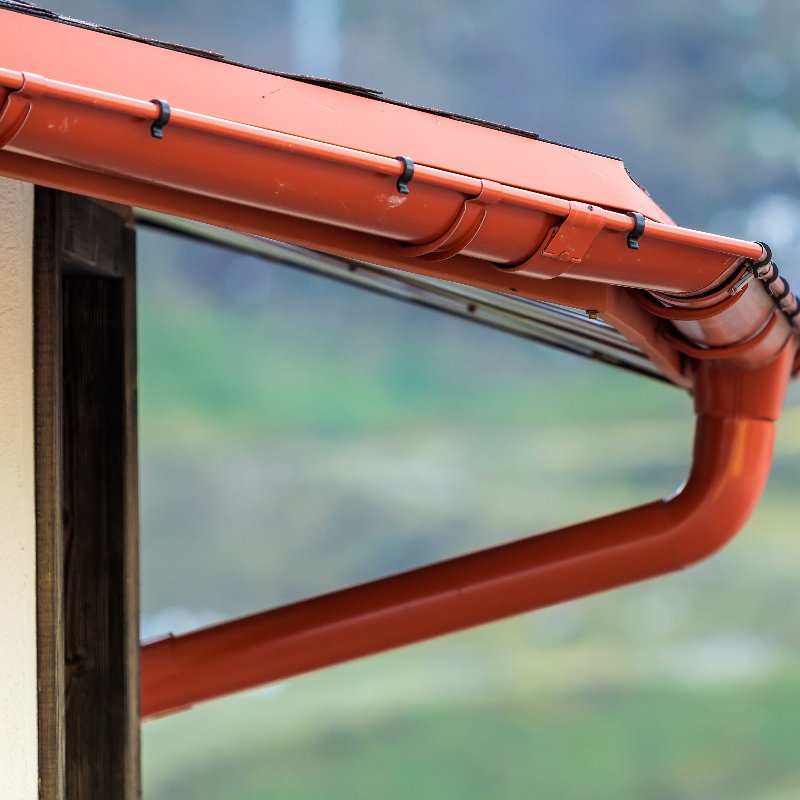 close-up of red gutters on a home