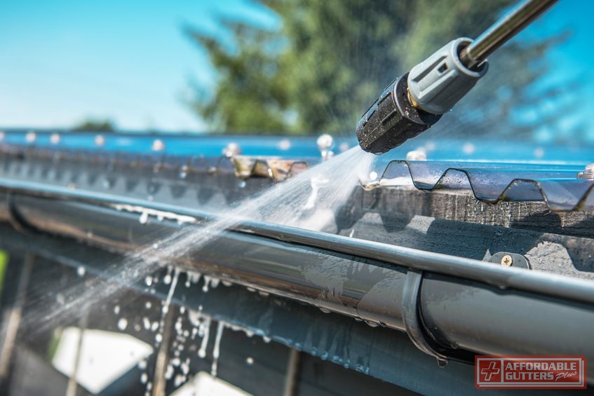 A Picture of a Pressure Washer Being Used to Clean Gutters.