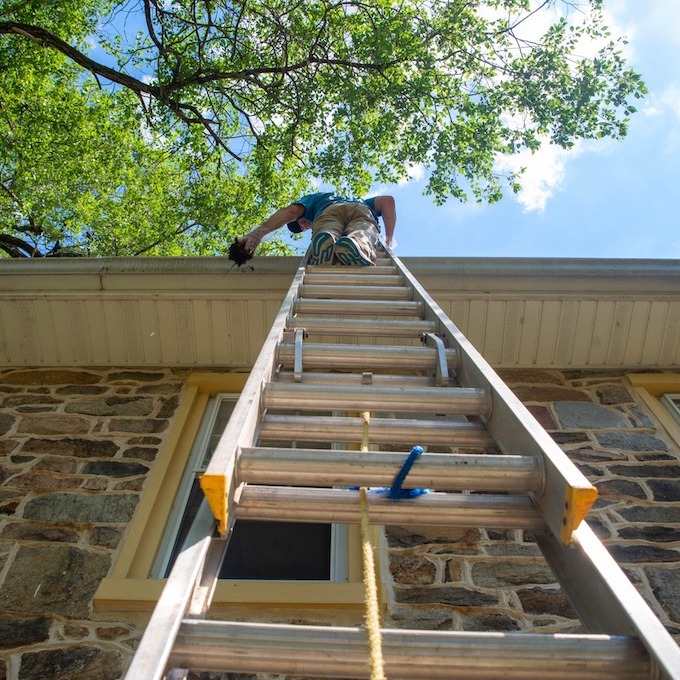 Roofer checking gutters